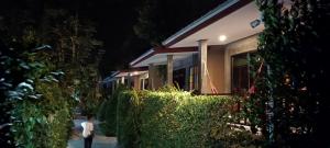 a man walking past a building at night at Fill - Feel @ Long Beach Resort in Ko Lanta