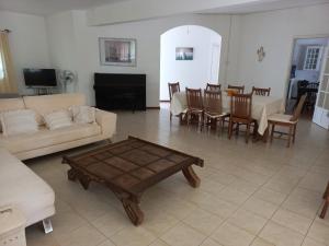 a living room with a couch and a table at Villa L'Oiseau Bleu in Pereybere