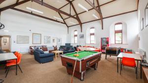 a living room with a pool table in it at Greenhead Hostel in Greenhead