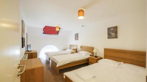 a hotel room with two beds and a room with two at Greenhead Hostel in Greenhead