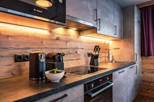 a kitchen with a counter top with a coffee maker at Gästehaus Wiesengrund & Apart Sporer in Mayrhofen