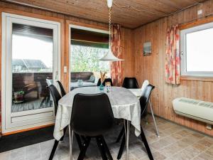 a dining room with a table and chairs at 6 person holiday home in R m in Bolilmark