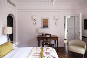 a bedroom with a bed and a desk and a chair at Splendido, A Belmond Hotel, Portofino in Portofino