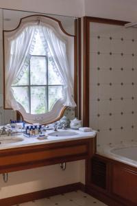 a bathroom with a sink and a window and a tub at Splendido, A Belmond Hotel, Portofino in Portofino