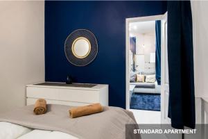
a room with a bed and a mirror at BpR Margaret - Savouir Suite Apartments in Budapest
