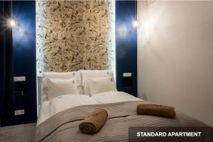 a bed with two towels on top of it at Savouir Bleu Suite near Danube in Budapest