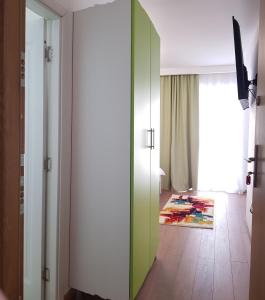 a room with a green sliding door and a hallway at Apartament 7 Budiu in Târgu-Mureş