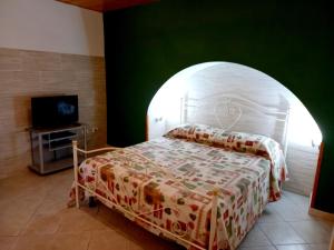 a bedroom with a bed and a green wall at Celebrity House in Marsala