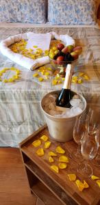a table with a bottle of wine and a bowl of fruit at Amanhecer na Serra in Urubici +10 photos
