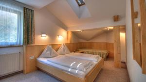a small bedroom with a bed and a window at Apart Am Arlen in Sankt Anton am Arlberg