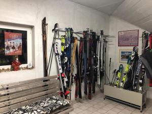 a bunch of skis are lined up against a wall at Hotel Fortuna in Ortisei
