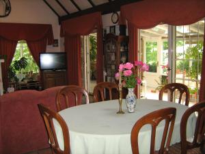 a table with a vase of flowers on it at Guest House Westwood in Kraljevec Kupinečki