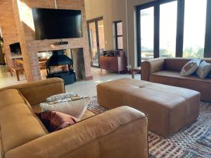 a living room with a couch and a fireplace at 4 Zwaan in Jeffreys Bay