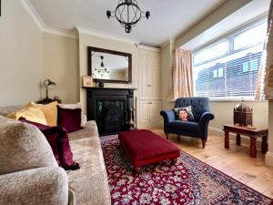 a living room with a couch and a fireplace at Mill Cottage, New Refurbished, 2 Bed, Cleethorpes in Cleethorpes