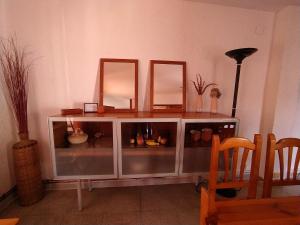 a cabinet with three mirrors on top of it at Apartamento Can Jaramills in Tordera