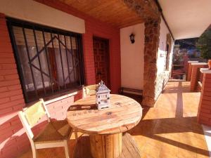 a wooden table and chairs on a patio at Apartamento Can Jaramills in Tordera