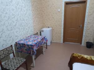 a room with a table and chairs and a door at ВВ-ХОСТЕЛ in Kyiv