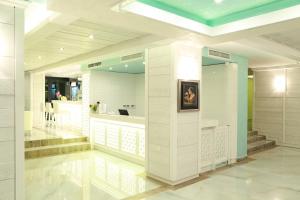 a large white room with a staircase and a mirror at Perla Royal Hotel - All Inclusive in Primorsko +88 photos