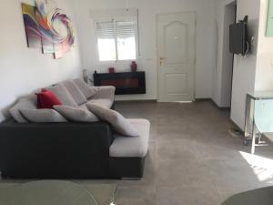 a living room with a couch and a television at FREDOV in Benalmádena
