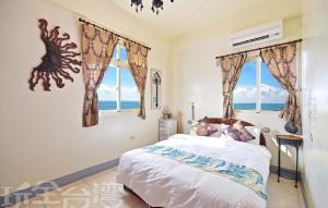 Postel nebo postele na pokoji v ubytování 沿海地帶 海景民宿 coastland B&B