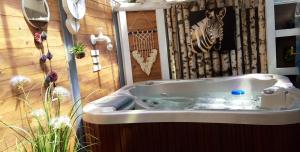 a bath tub with a zebra on the wall at Loft dans les Vosges idéal 2 personnes in Le Thillot