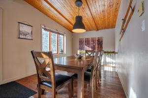 a dining room with a wooden table and chairs at COZY CHALET WELL LOCATED in Saint-Faustin