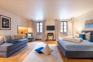 a living room with two beds and a couch at Augustiner in Meran in Merano