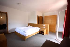 a bedroom with a bed and a large window at Residence Haus Ragen in Brunico