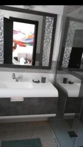 a bathroom with a sink and a mirror and a toilet at FREDOV in Benalmádena +34 photos