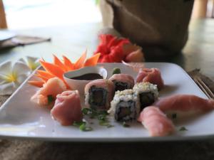 a plate of sushi with a bowl of soy sauce at Cristal Resort in Paje