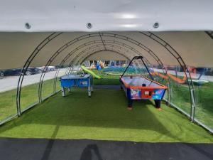 a play tent with two trampolines and a playground at Holiday Homes 777 in Karwia