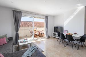 a living room with a couch and a table at Amarillo Apartments in Mlini