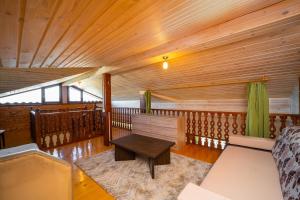 a room with a couch and a table on a balcony at Villa Makeli in Rogachevo