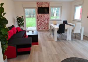 a living room with a couch and a table at Ferienwohnung / Messeunterkunft in Willich