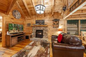 a living room with a couch and a fireplace at Moose Tracks cabin in Pigeon Forge