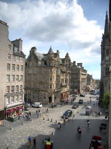 a city street with buildings and a clock tower at Royal Mile, Edinburgh - 2 Bedroom Apartment in Edinburgh
