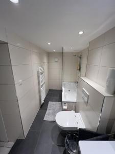 a bathroom with a sink and a toilet in it at city rooms luxembourg in Luxembourg