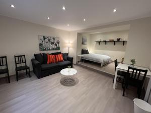 a living room with a couch and a bed at city rooms luxembourg in Luxembourg