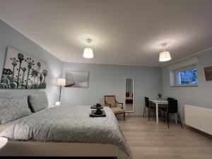 a bedroom with a bed and a dining room with a table at city rooms luxembourg in Luxembourg