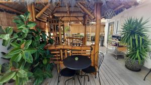 a restaurant with a table and chairs and plants at Hotel Maravillas del Mundo in Calpe
