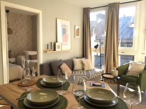 a living room with a table with plates and wine glasses at Joya en Orense Centro in Ourense