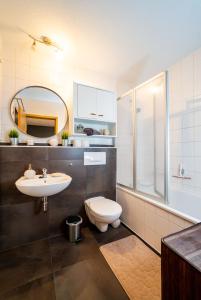 a bathroom with a sink toilet and a mirror at Bördeapartment 1 in Vahldorf