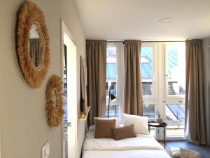 a bedroom with a bed and a large window at Joya en Orense Centro in Ourense