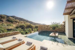 a villa with a swimming pool with a view at Hide Out Villas in Mylopotas