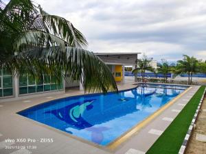 a swimming pool in front of a building at PavilionVillie Ipoh in Kampong Sengat