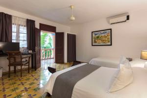 Postel nebo postele na pokoji v ubytování Hotel Villa Colonial