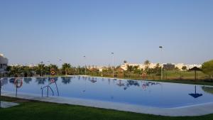 a large swimming pool in a resort at Apartments Sol de Almeria Golf y Playa II in Almería +12 photos