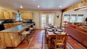 a kitchen and living room with a table and chairs at Arena Roja #2279 in Moab