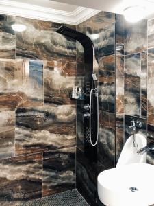 a bathroom with a wall mural of clouds at Coral Tree Inn in Pretoria