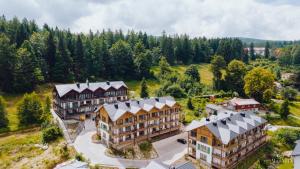 an aerial view of a resort with trees and buildings at Apartament Silence Karpatia Resort Koral in Karpacz